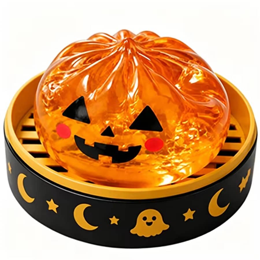 Pumpkin Squishy Dumpling in a black and gold steamer basket